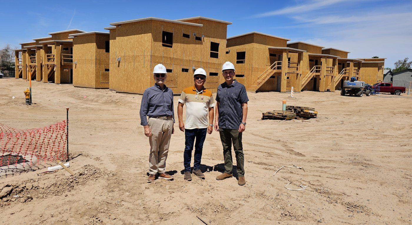 Ron Ramos with capital partner Joel Tubao and Kyle DeQuillettes in front of the framed buildings during construction